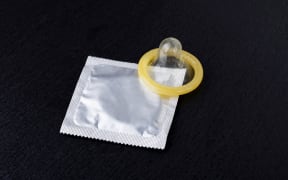condom and pack on a black background
