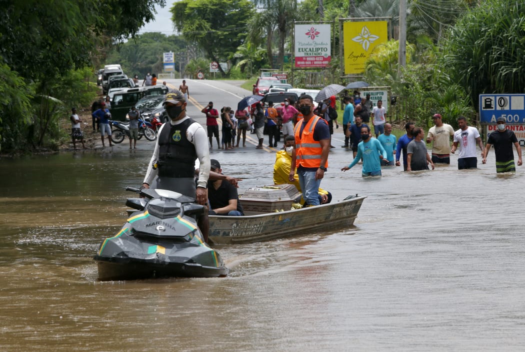 A member of the Navy helping to transport and empty coffin from Ilheus to the Costa do Cacau Regional Hospital in Itabuna, during floods.