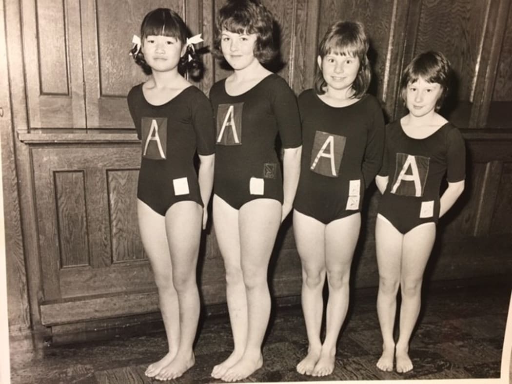Four young gymnasts in a line