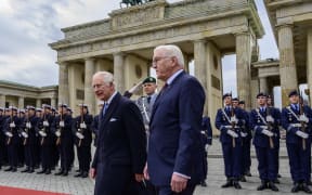 Britain's King Charles III and German President Frank-Walter Steinmeier inspect a guard of honour during a ceremonial welcome at Brandenburg Gate in Berlin, on March 29, 2023. - Britain's King Charles III began his first state visit, having postponed a trip to France due to widespread political protests. Charles will undertake engagements in the German capital and in Brandenburg before heading to Hamburg during the three-day tour. (Photo by John MACDOUGALL / AFP)
