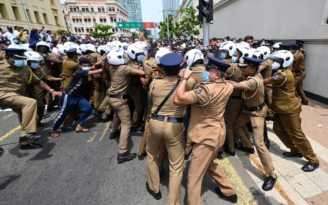 Government supporters and police clash outside the president's office in Colombo on 9 May 2022.
