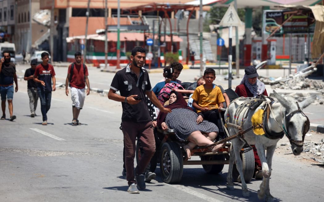 Displaced Palestinians are fleeing from Gaza City and are walking along Salah al-Din Street as they are arriving at the Nuseirat refugee camp in the central Gaza Strip on July 10, 2024, amid the ongoing battles between Israel and the militant group Hamas. (Photo by Majdi Fathi/NurPhoto) (Photo by MAJDI FATHI / NurPhoto / NurPhoto via AFP)