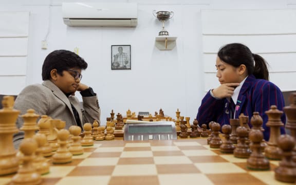 Chess player Sai and Luna Lu are playing in the Auckland chess center.