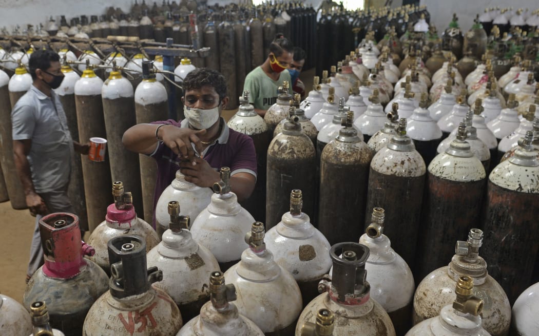 Workers arrange medical oxygen cylinders to be transported to hospitals amid Covid-19 coronavirus pandemic at a facility on the outskirts of Chennai on April 24, 2021.