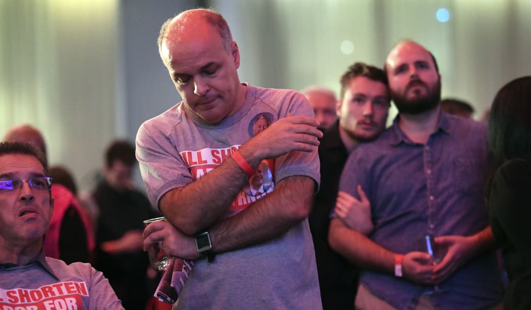 Supporters of opposition Labor leader Bill Shorten watch the giant screens showing the results of Australia's general election in Melboune on May 18, 2019.
