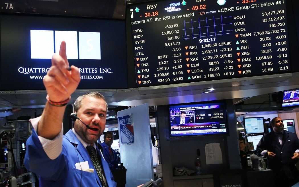 A trader on the floor of the New York Stock Exchange as the global economy continues to react from events in China.