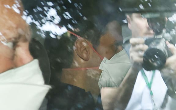 Novak Djokovic wears a face mask as he arrives at the lawyer's office in Melbourne on 16 January 2022.