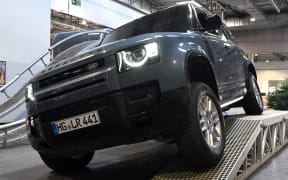 29 January 2024, North Rhine-Westphalia, Dortmund: A Land Rover Defender drives over an obstacle course in an exhibition hall. From 29 January to 4 February 2024, Dortmund's Westfalenhallen will host "Jagd und Hund", Europe's largest public trade fair for hunting enthusiasts according to the organizers. From hunting weapons to outdoor and loden clothing to night vision devices and high seats: Suppliers of hunting equipment from 39 countries will be presenting their new products there. Photo: Federico Gambarini/dpa (Photo by FEDERICO GAMBARINI / DPA / dpa Picture-Alliance via AFP)