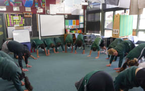 Students from Room 1 at Avalon Intermediate school do yoga.