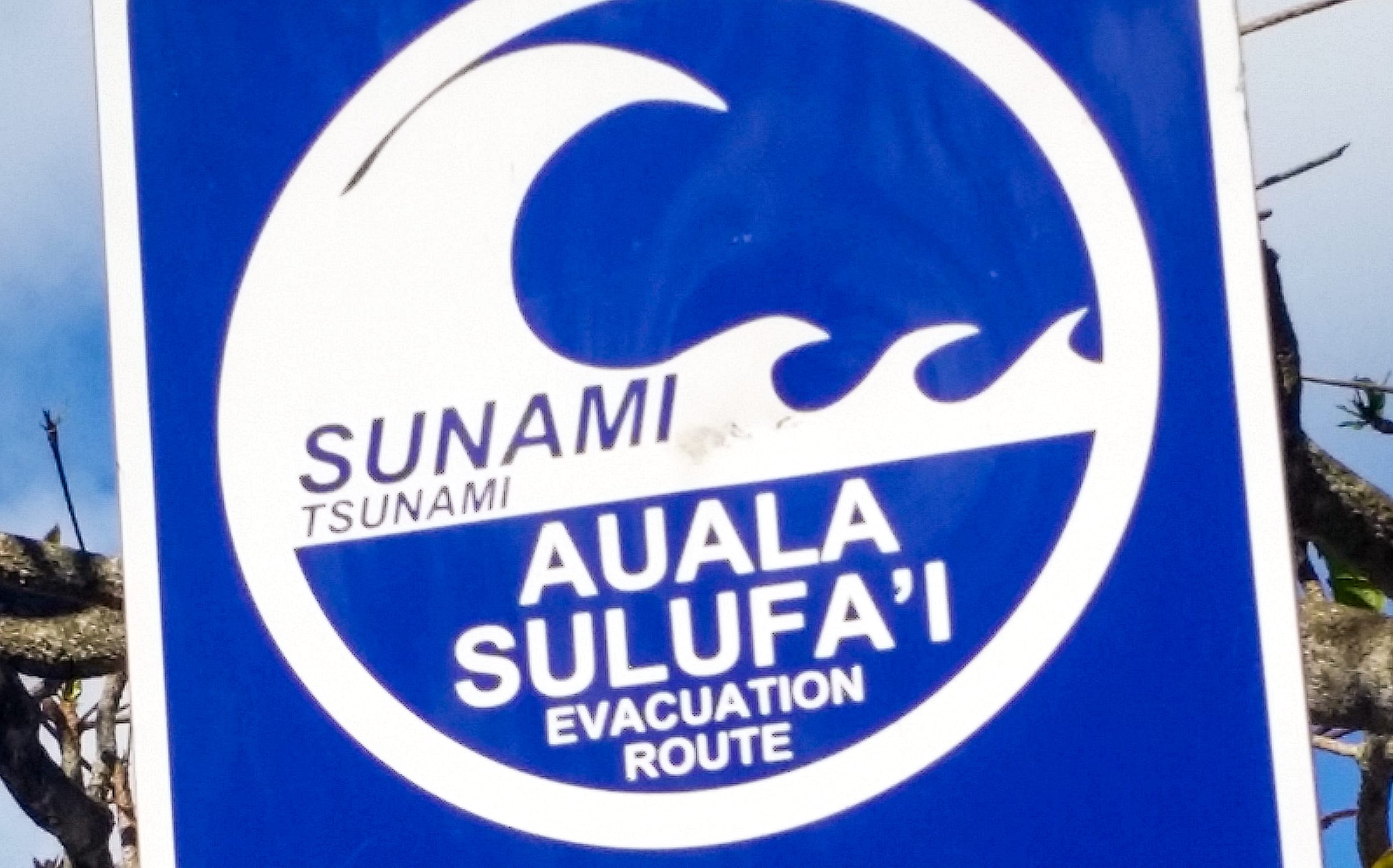 A sign on the beach directs people to the tsunami escape route.