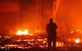 Marshall Islands firefighters try to contain the fire.