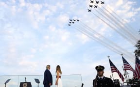 WASHINGTON, DC - JULY 04: U.S. President Donald Trump and first lady Melania Trump watch the U.S. Navy Blue Angels and U.S. Air Force Thunderbirds perform a flyover near the White House on July 04, 2020 in Washington, DC.