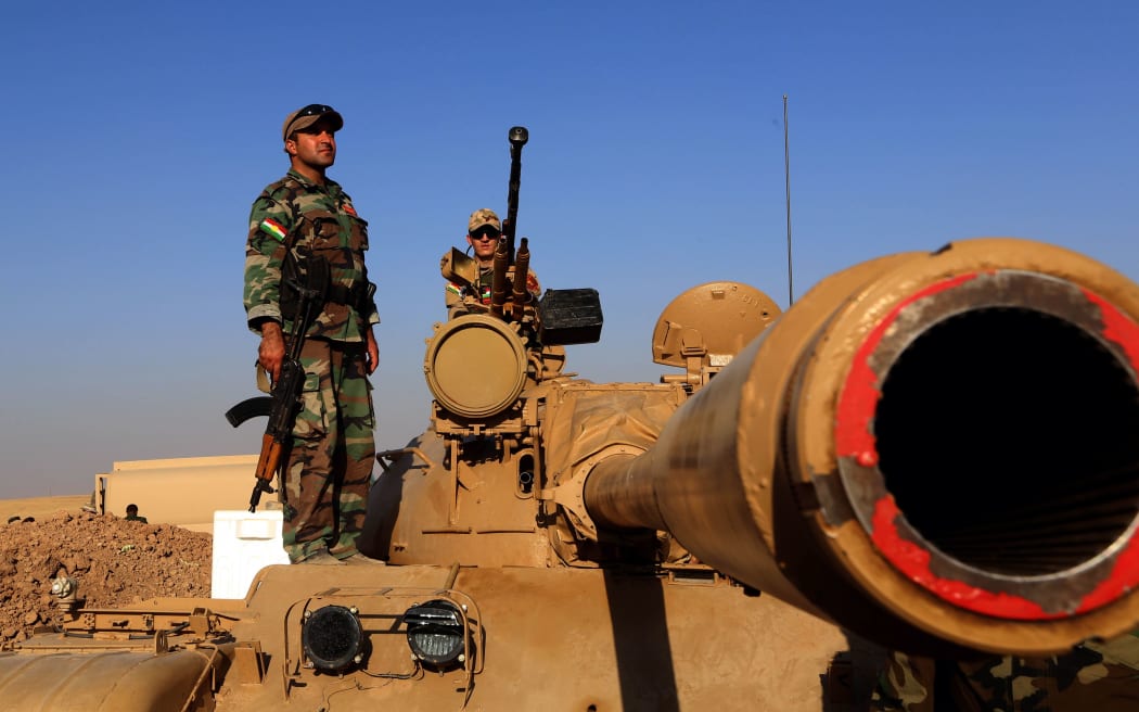 Iraqi Kurdish Peshmerga fighters take on the front line in Khazer, near the Kurdish checkpoint of Aski kalak.