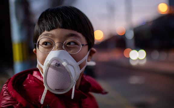 A child in Beijing, wearing a protective mask, 29 Janaury.