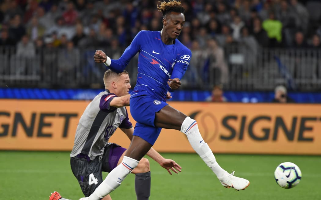 Chelsea's Tammy Abraham attempts a shot on goal in front of Perth Glory's Shane Lowry