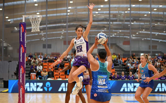 Anna Harrison of the Stars leaps high to block Elisapeta Toeava of the Mystics.