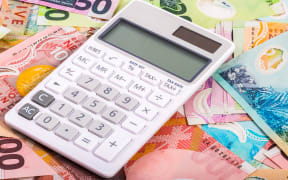 calculator and dollar bills in New Zealand currency