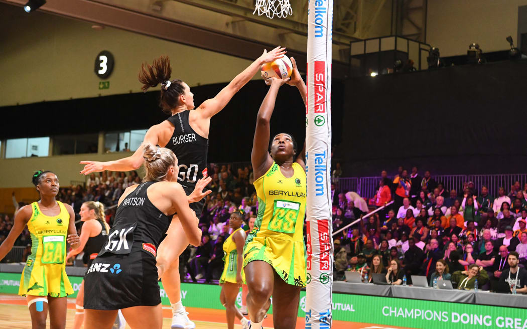 Jamaica's Jhaniele Fowler scores against New Zealand's Karin Burger during their bronze medal play-off in the Netball World Cup in Cape Town on 06 August 2023.