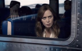 Emily Blunt looks out the train window