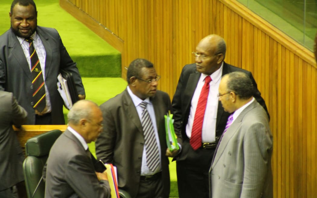 Members of the Papua New Guinea government, including Treasurer Patrick Pruaitch (centre) and Prime Minister Peter O'Neill (right)