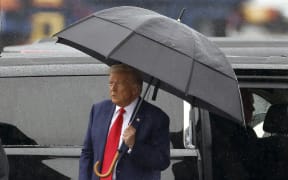 ARLINGTON, VIRGINIA - AUGUST 03: Former U.S. President Donald Trump holds an umbrella as he arrives at Reagan National Airport following an arraignment in a Washington, D.C. court on August 3, 2023 in Arlington, Virginia. Former U.S. President Donald Trump pleaded not guilty to four felony criminal charges during his arraignment this afternoon after being indicted for his alleged efforts to overturn the 2020 election.   Tasos Katopodis/Getty Images/AFP (Photo by TASOS KATOPODIS / GETTY IMAGES NORTH AMERICA / Getty Images via AFP)