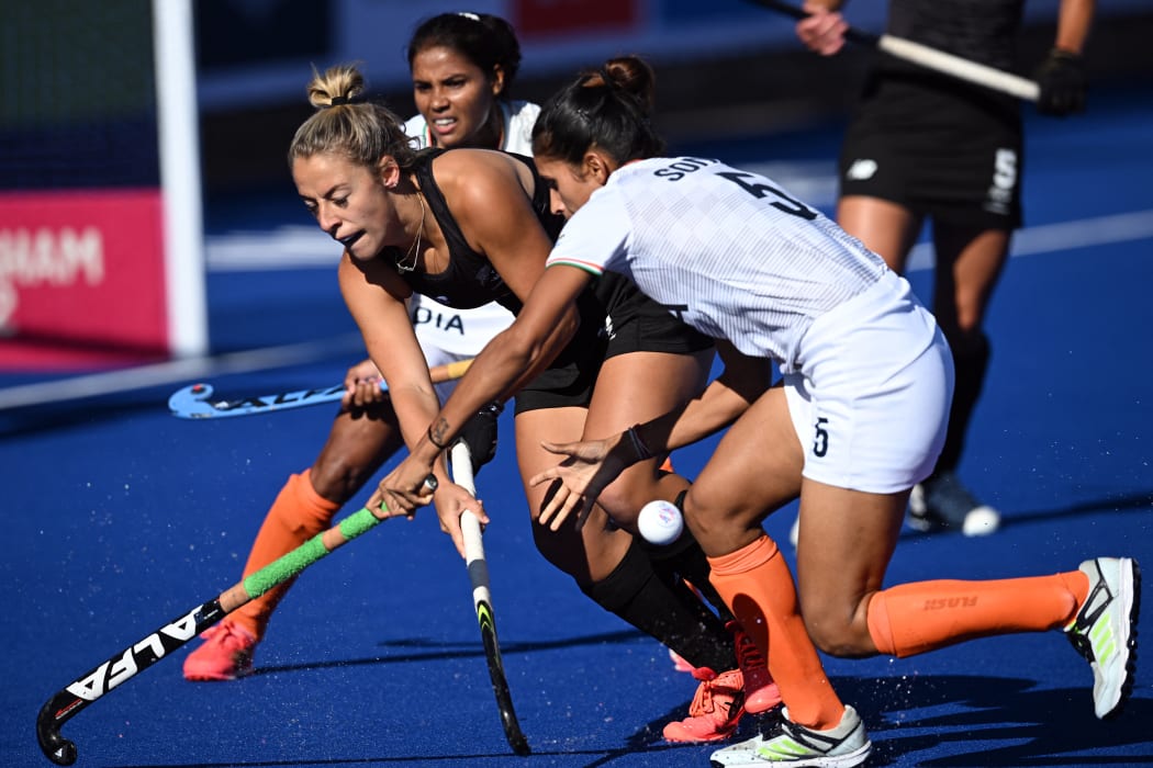 New Zealand's Alex Lukin (L) comes under pressure from India's Sonika (R) during the women's bronze medal hockey match between New Zealand and India on day ten of the Commonwealth Games in Birmingham, central England, on August 7, 2022. (Photo by Paul ELLIS / AFP)