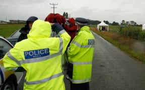 Police officers at the site of the crash in January 2012.