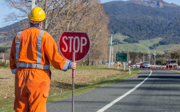 Signs repairs road and worker