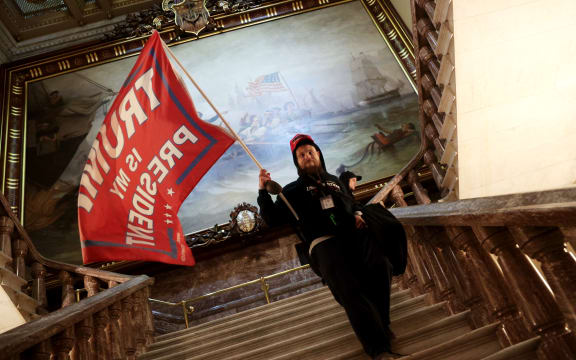 A protester holds a Trump flag inside the US Capitol Building near the Senate Chamber on January 06, 2021 in Washington, DC.