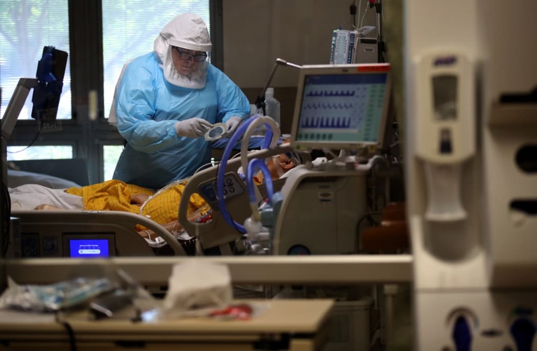 SAN JOSE, CALIFORNIA - MAY 21: (EDITORIAL USE ONLY) A nurse wears personal protective equipment (PPE) as she cares for a coronavirus COVID-19 patient in the intensive care unit (I.C.U.) at Regional Medical Center on May 21, 2020 in San Jose, California.
