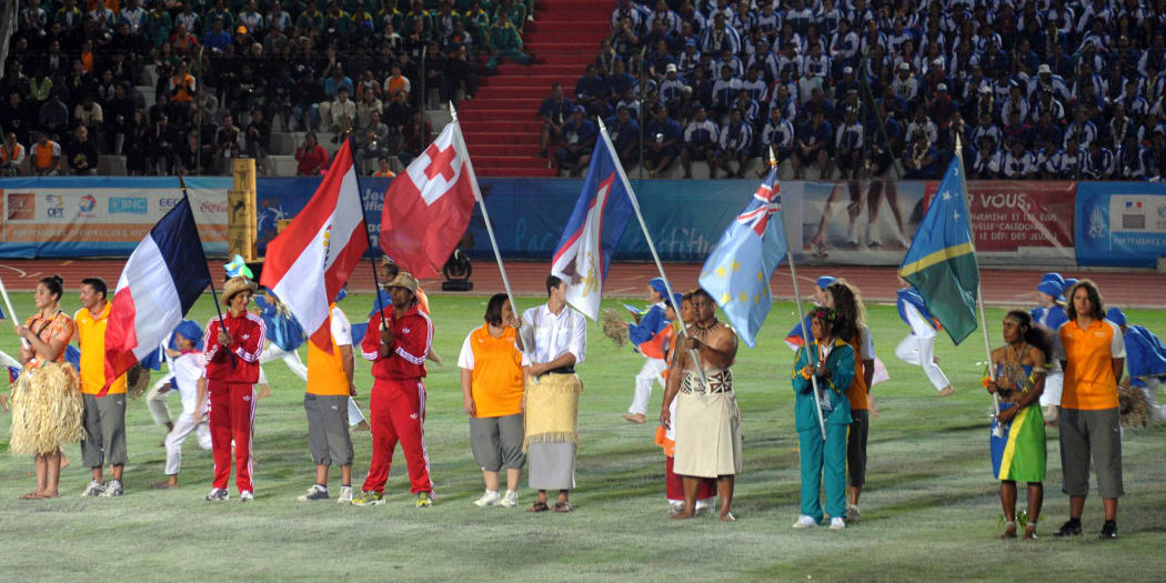 Athletes pose with their delegations' respective flags during the Opening Ceremony for the 14th Pacific Games, in 2011, in New-Caledonia.