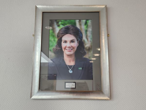 A framed photograph of a well-groomed woman in her early 60s, Pauline Hanna.