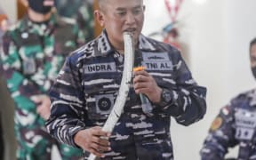 Indonesian Navy personnel shows one of debris from missing Indonesian navy submarine KRI Nanggala 402