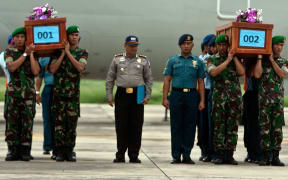 Indonesian military personnel carry coffins of victims recovered from AirAsia flight QZ8501.