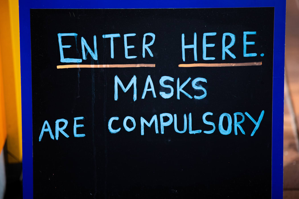Sign outside a business which reads "Masks are compulsory"