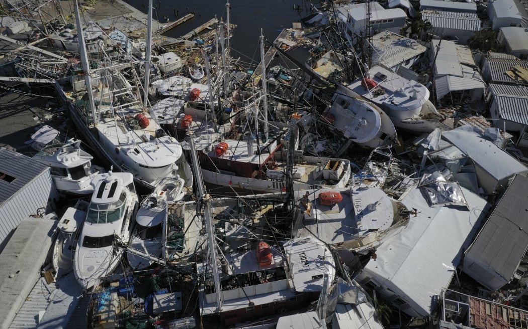 In this aerial view, boats sit atop one another in a marina near Fort Myers Beach on 29 September, 2022 in San Carlos Island, Florida.