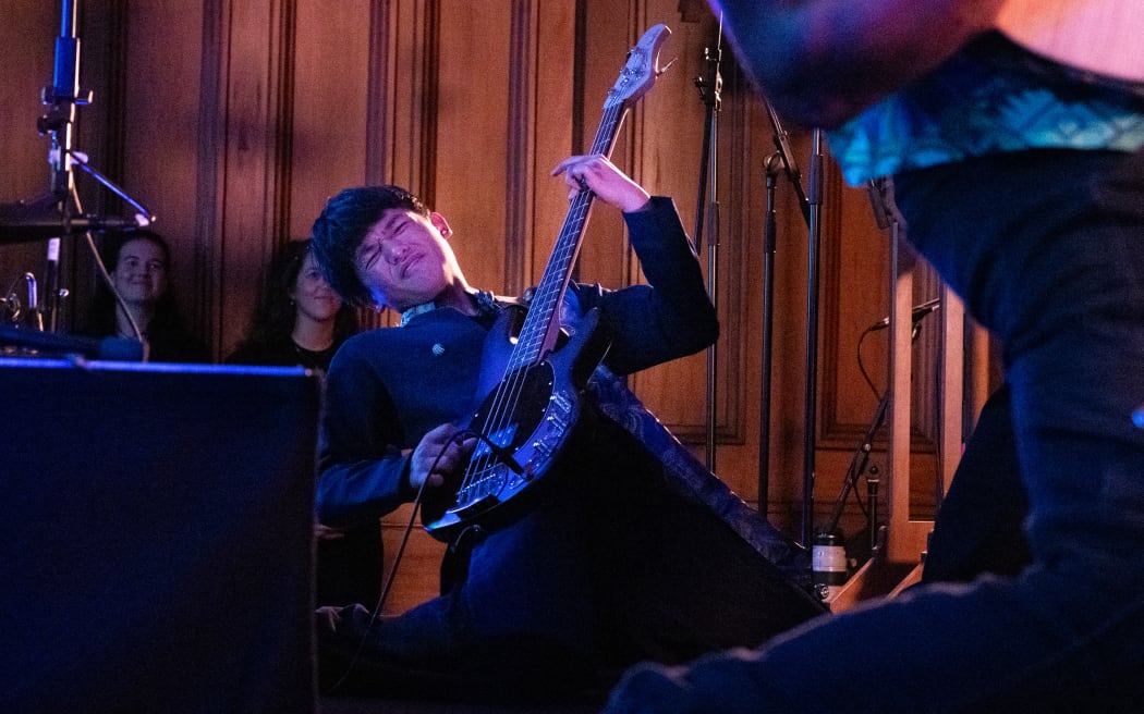 The guitarist from Top Shelf shreds on his knees. Top Shelf are from Manurewa High School, and 2024 winners of both Smokefree Rockquest and Smokefree Tangata Beats.