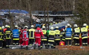 Firefighters and emergency doctors work at the site of a train accident near Bad Aibling, southern Germany, on February 9, 2016.