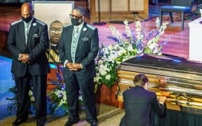 Minneapolis Mayor Jacob Frey, right,  pays his respects at the memorial service for George Floyd in Minneapolis, Minnesota.