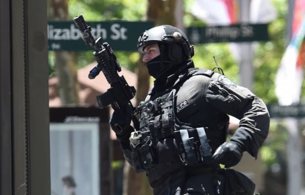 An armed officer outside the Lindt cafe during the 2014 Sydney seige.