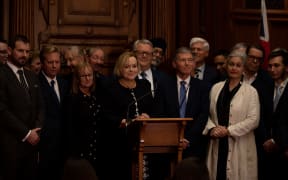National Party leader Judith Collins addresses media with support from party members following the emergency caucus meeting on 14 July.