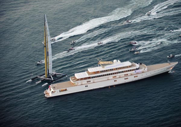 US challenger Oracle giant trimaran (L) sails next to Oracle's owner Larry Ellison's motor yacht Rising Sun during the second race of the 33rd America's Cup on February 14, 2010 off Valencia's coast.