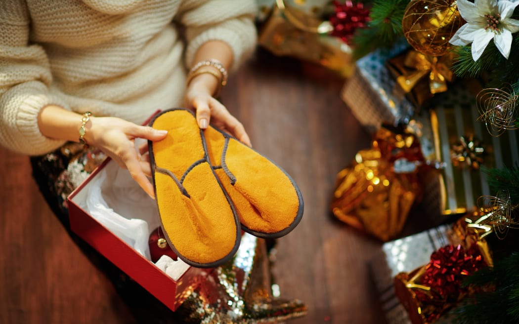 Christmas tree near present boxes, slippers.