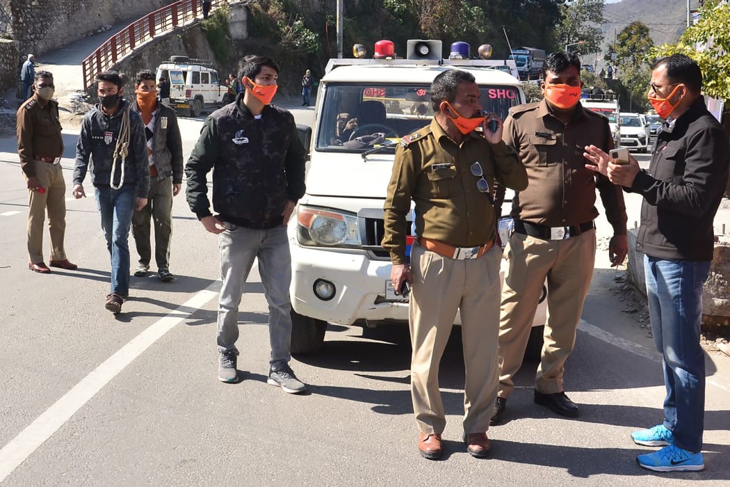 Police personnel prepare after a glacier broke off in India's Chamoli district causing flash floods in the Dhauli Ganga river