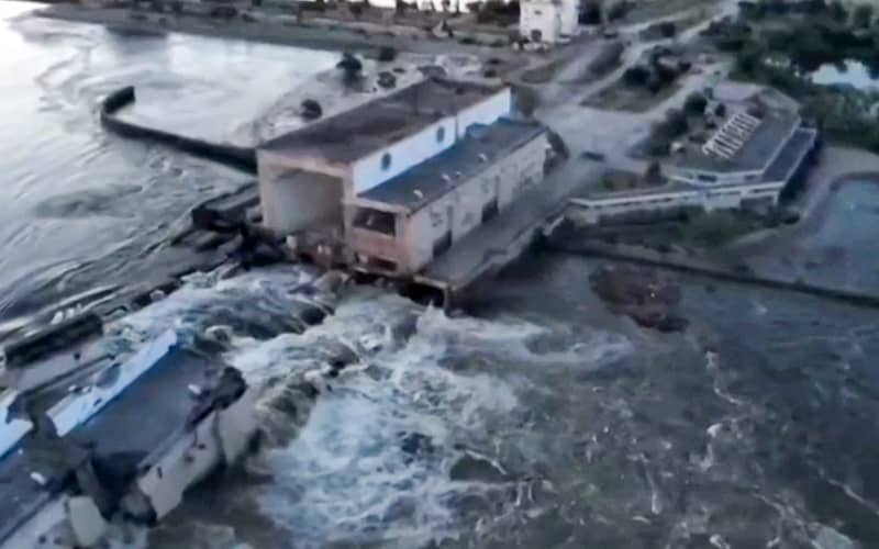 This screen grab from a video posted on Ukraine’s President Volodymyr Zelensky’s Twitter account on June 6, 2023 shows an aerial view of the dam of the Kakhovka Hydroelectric Power Station after it was partially destroyed.