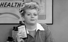 [Actress Lucille Ball drinking from a hip flask and slumping]