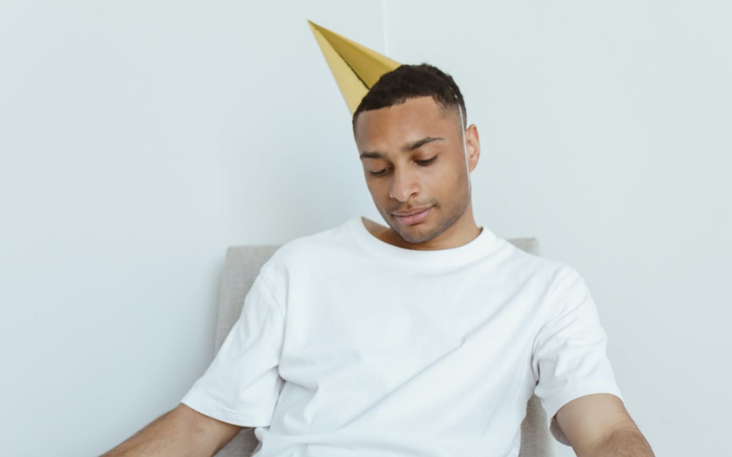 Man in white tshirt and party hat