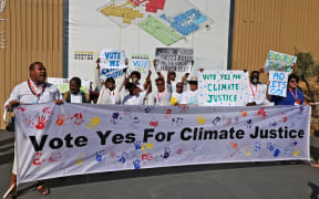 Members of Pacific Island Students Fighting Climate Change stage a protest during the COP27 climate conference in Sharm el-Sheikh, Egypt