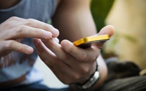 lifestyle young man using a mobile phone with texting message on app smartphone, playing social network and shopping online