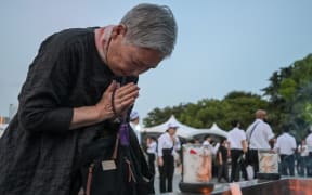 A woman prays at the Peace Memorial Park ahead of the memorial service to mark the 80th anniversary of the world's first atomic bomb attack, in the city of Hiroshima.